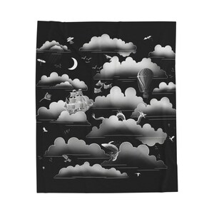May include: Black and white blanket featuring a whimsical cloudscape design. The design includes a sailing ship, hot air balloon, dragon, and various birds. A crescent moon is also visible in the design.