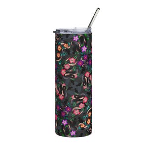 May include: A stainless steel tumbler with a black snake and floral pattern. The design features black snakes intertwined with pink, orange, and purple flowers on a dark gray background. Includes a silver straw and a black lid.