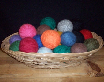 May include: A wicker basket filled with colorful felt balls. The balls are in various shades of red, green, blue, orange, and purple.