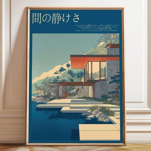 May include: Framed art print featuring a modern house with a red roof and large windows, set against a mountain backdrop and a body of water. The print has Japanese text at the top and is in a minimalist style.