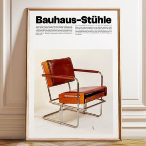 May include: A framed poster titled Bauhaus-St&uuml;hle featuring a photograph of a chair with a chrome metal frame, a wooden backrest, and a red leather seat and back cushion. The poster includes descriptive text in German about the chair design.