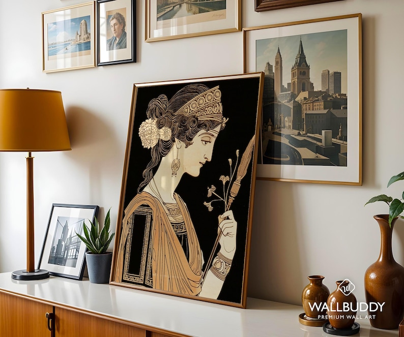 May include: A framed art print featuring a stylized illustration of a person in profile with an intricate hairstyle, wearing a patterned headband and draped garment, holding a long thin staff against a solid black background.