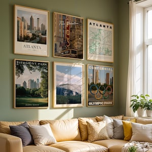 May include: Six framed wall art prints featuring Atlanta landmarks including the city skyline, Fox Theatre, a city map, Piedmont Park, Stone Mountain, and Centennial Olympic Park, displayed in a grid arrangement on a sage green wall above a sofa.