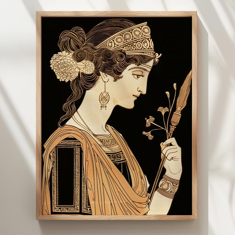 May include: A framed wall art print featuring a profile illustration of a figure with dark hair styled in an updo with floral accents, wearing a patterned headband, drop earrings, and a draped garment, holding a long staff with floral details.