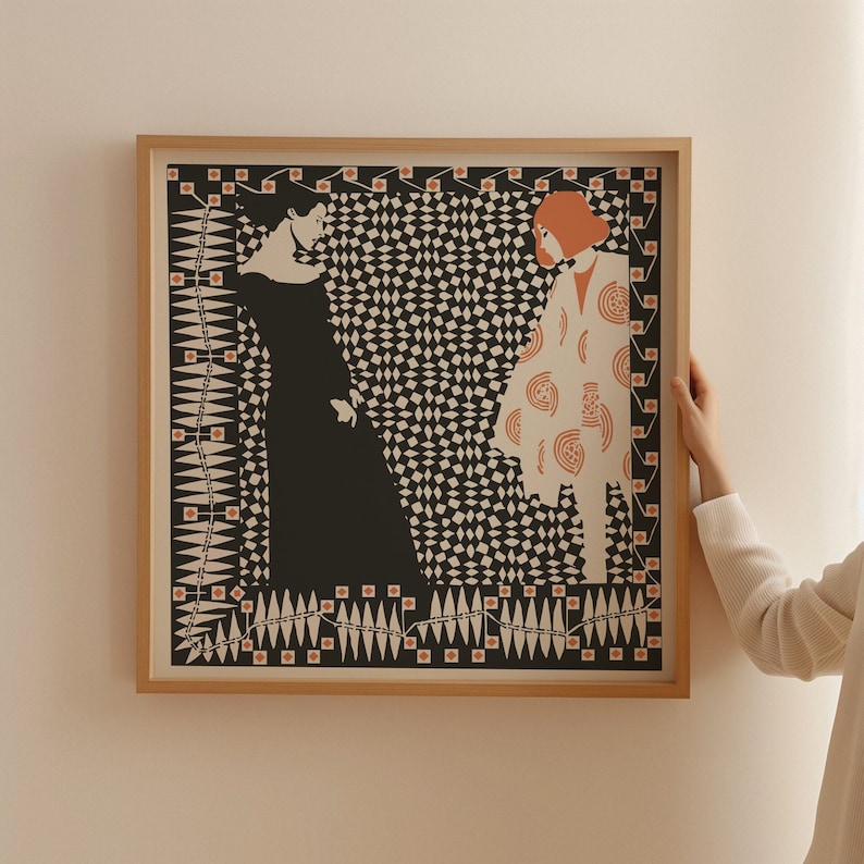 May include: A square framed art print featuring a graphic illustration of two figures. One figure wears a solid black dress, while the other wears a white coat with orange circular patterns. The background is a black and white diamond pattern.