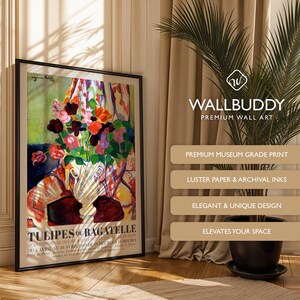 May include: A framed art print titled Tulipes de Bagatelle featuring a colorful floral arrangement in a vase with red, pink, and orange tulips. The poster includes text at the bottom and is displayed in a black frame against a wall.