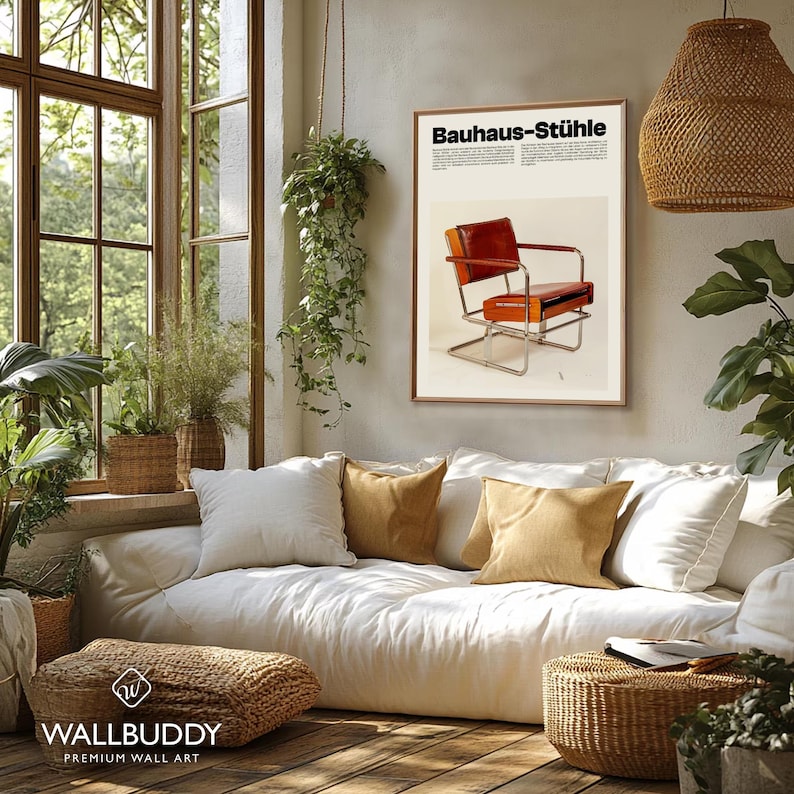 May include: A rectangular wall art print titled Bauhaus-St&uuml;hle featuring a brown leather chair with a chrome frame. The poster has a cream background with black text and is displayed in a thin wooden frame on a light-colored wall above a sofa.