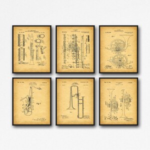 May include: Set of six vintage patent drawings for musical instruments, including a flute, clarinet, french horn, trombone, saxophone, and trumpet. Each drawing is in black and white and features detailed illustrations of the instruments.