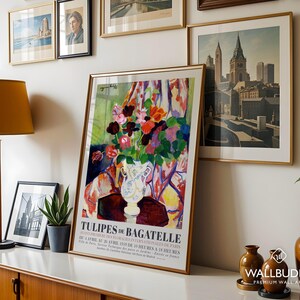 May include: A framed art print titled TULIPES DE BAGATELLE featuring a colorful floral arrangement in a white vase. The poster includes text detailing the 1939 Paris floral exhibition dates and times, set against a vibrant, abstract background.