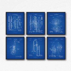 May include: Set of six vintage blueprint style prints of musical instruments. The prints feature a clarinet, flute, french horn, saxophone, trombone, and trumpet. Each print includes the patent number, inventor, and date.