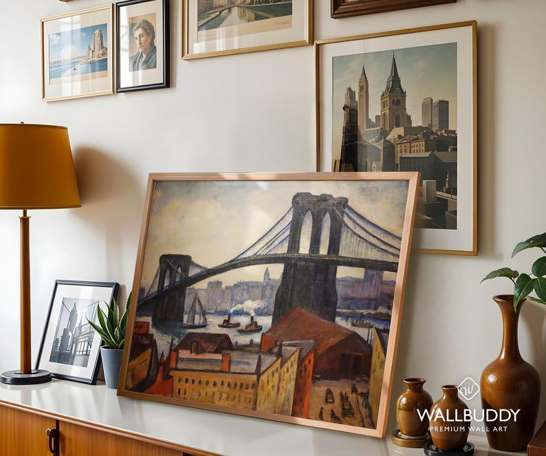May include: A framed art print featuring a painting of the Brooklyn Bridge with a cityscape, harbor, and buildings in the foreground. The artwork uses a palette of blues, browns, and yellows to depict the bridge structure, boats, and urban architecture.