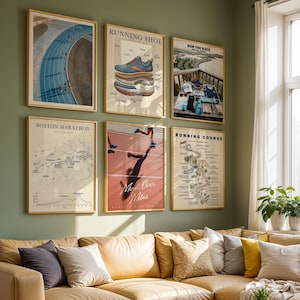 May include: Six framed posters displayed on a green wall above a tan sofa. The prints feature running-themed imagery, including a track, a diagram of a running shoe, a race day flat lay, a Boston Marathon map, a runner's shadow, and a course map.