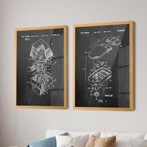 May include: Two framed patent diagrams with a black background and white illustrations. The left frame shows an exploded view of a device, labeled "FIG. 1" and "U.S. Patent Oct. 23, 1984". The right frame depicts a mouse, labeled "FIG. 1" and "U.S. Patent Aug. 4, 1998".