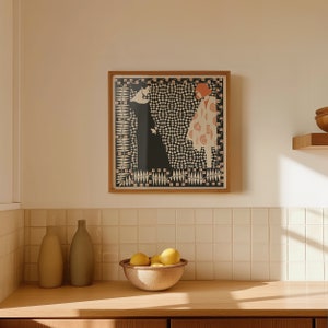 May include: A square framed wall art print featuring a graphic illustration of two figures facing each other. One figure wears a solid black dress, while the other wears a light-coloured patterned coat. The background is a dense black and white pattern.