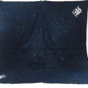 May include: A large indigo-dyed textile with white Japanese characters in two corners. The fabric has a textured appearance with lighter areas, suggesting a vintage or handcrafted origin. The textile is displayed against a white background.