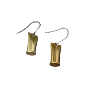 May include: A pair of earrings with a gold-colored, cylindrical design. The earrings have a silver-colored hook. The earrings are displayed against a white background.