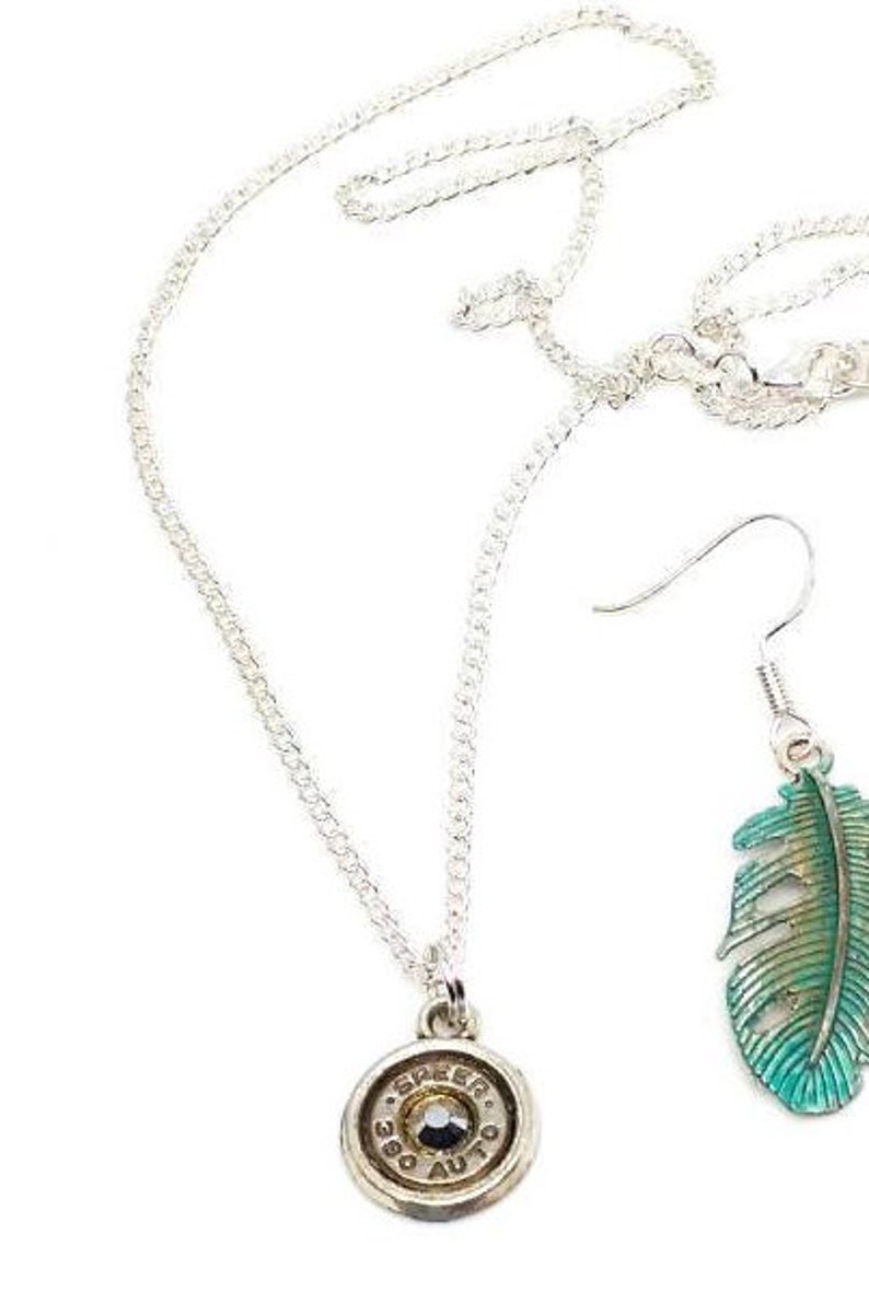 Metallic silver bullet necklace and painted feather earrings