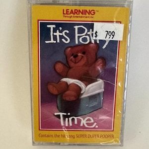 May include: A yellow cassette tape with a cartoon bear sitting on a blue potty. The cassette tape is labeled "It's Potty Time" and "Contains the hit song SUPER DUPER POOPER".