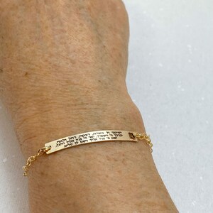 May include: A gold bracelet with a Hebrew inscription that reads: "May the Lord turn His face to you and grant you peace. May He turn His face to you and bless you and protect you."