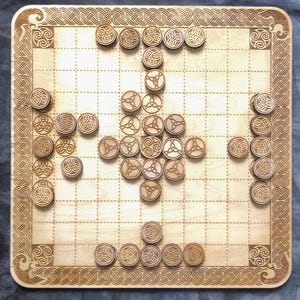 May include: A wooden board game with a Celtic knot design. The board has a grid pattern with circular game pieces. The border and game pieces feature intricate Celtic knot patterns. The game pieces are arranged in a cross formation.