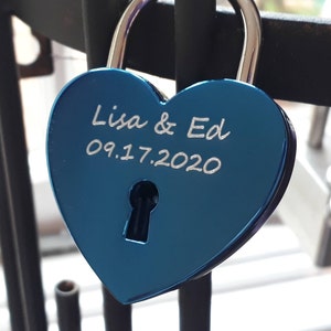 May include: A blue heart-shaped padlock with the inscription "Lisa & Ed 09.17.2020".