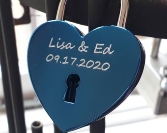 May include: A blue heart-shaped padlock with the inscription "Lisa & Ed 09.17.2020".