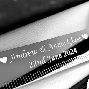 May include: Silver knife engraved with "Andrew & Annie Glass 22nd June 2024" and two hearts.