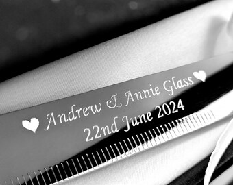 May include: Silver knife engraved with "Andrew & Annie Glass 22nd June 2024" and two hearts.