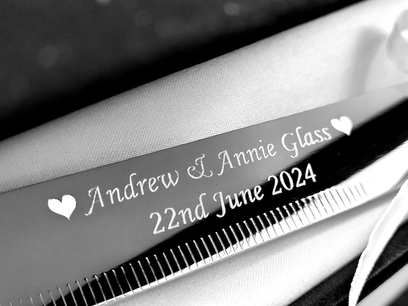 May include: Silver knife engraved with "Andrew & Annie Glass 22nd June 2024" and two hearts.
