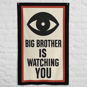 May include: A rectangular wall hanging with a black border, red inner border, and a cream-colored center. The center features a black eye graphic above the text "BIG BROTHER IS WATCHING YOU" in bold, black font.