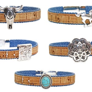 May include: Five cork bracelets with denim blue lining and silver-tone metal accents. The bracelets feature a bull skull, horse, square floral design, round floral design, and an oval turquoise stone.