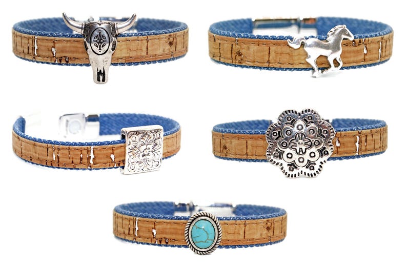May include: Five cork bracelets with denim blue lining and silver-tone metal accents. The bracelets feature a bull skull, horse, square floral design, round floral design, and an oval turquoise stone.