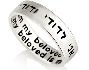 May include: A silver ring with the Hebrew words "Beloved is mine" and the English words "My beloved is mine" engraved on it.