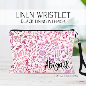 This linen wristlet zipper pouch features a mahjong cards covering the whole bag and personalized name at the bottom. Choose your colors and font.