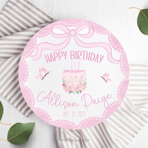 May include: A pink and white birthday plate with the words "HAPPY BIRTHDAY" and "Allison Paige JULY 17, 2025". The plate features a cake, butterflies, and a bow design.