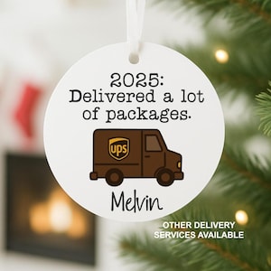 May include: A white round Christmas ornament with a ribbon for hanging. The ornament features a brown UPS truck graphic and the text "2025: Delivered a lot of packages." The name "Melvin" is below the truck. "OTHER DELIVERY SERVICES AVAILABLE" is at the bottom.