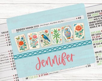 May include: A light blue personalized card holder featuring a series of illustrated cards with floral and bird designs. The name "Jennifer" is written in pink script across the front. The card holder has a decorative teal border.