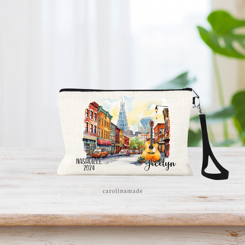 Beautiful watercolor design of downtown Nashville Tennessee  in the middle of this linen wristlet bag. It is personalized with your name on bottom right, with Nashville and the year on the bottom left.