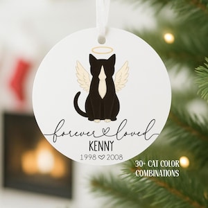 May include: A white, round ornament with a black and white cat angel design, complete with a halo and wings. The ornament reads "forever loved" and includes a name and dates. The text "30+ CAT COLOR COMBINATIONS" is also present.