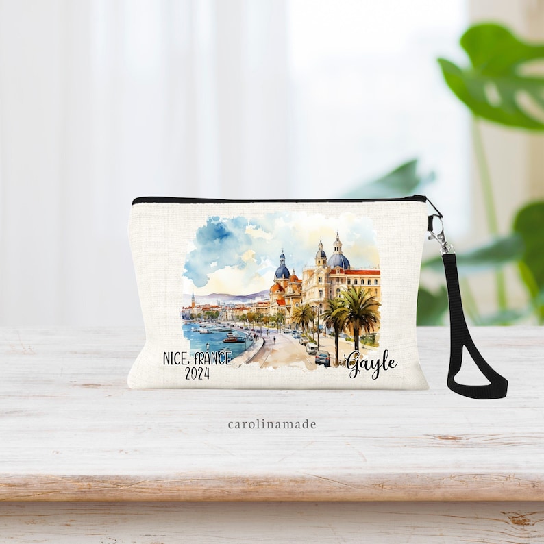 Beautiful watercolor design of Nice France in the middle of this linen wristlet bag. It is personalized with your name on bottom right, with Nice France and the year on the bottom left.