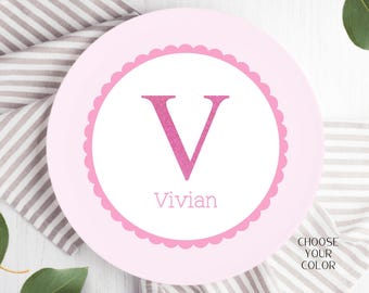 May include: Pink personalized plate with a scalloped border, featuring a large pink glitter letter "V" and the name "Vivian" in pink text.  Choose your color.