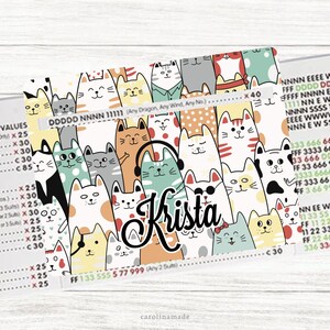May include: A colorful cat-themed design featuring various cartoon cats with different expressions and patterns. The name "Krista" is written in a cursive font. The background includes text and numbers.