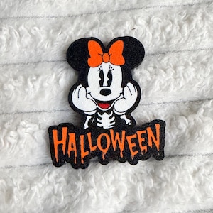 May include: A black and white character patch featuring a skeleton-themed mouse with an orange bow, hands resting on the face, and the word HALLOWEEN in orange dripping letters below. The design is outlined in black and has a textured surface.