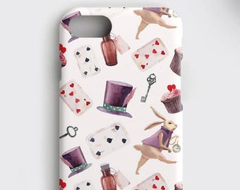 May include: A white phone case with a repeating pattern of playing cards, cupcakes, keys, a rabbit, and a top hat. The pattern is in shades of pink, purple, and brown.