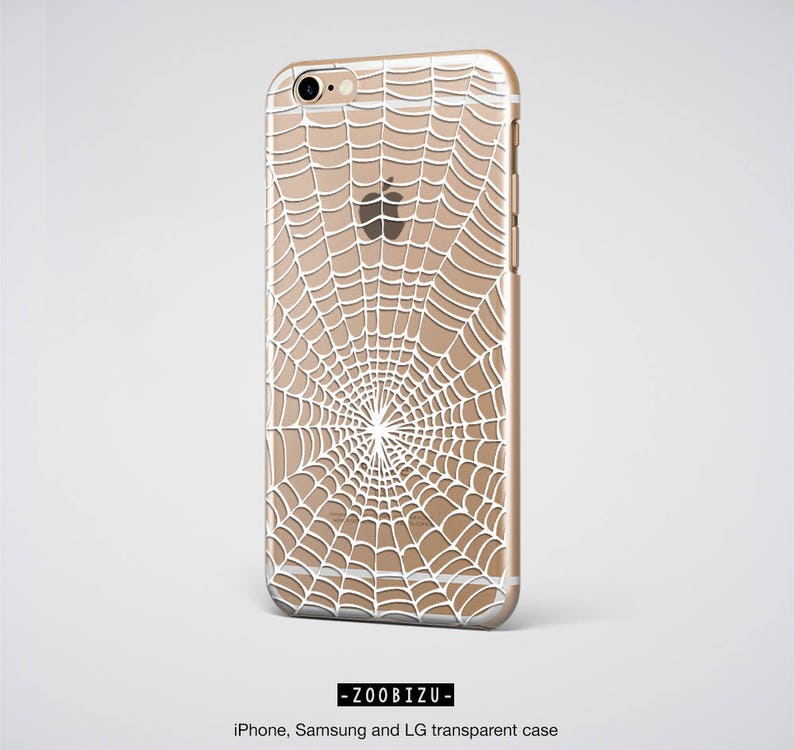 Peut inclure: Une coque de t&eacute;l&eacute;phone transparente avec un motif de toile d'araign&eacute;e blanche. La coque est compatible avec les t&eacute;l&eacute;phones iPhone, Samsung et LG.