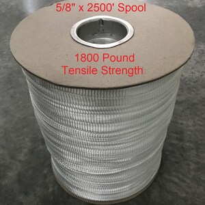 May include: A spool of white 5/8 inch wide strapping, 2500 feet long, with a 1800 pound tensile strength.
