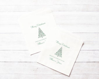 May include: Two white napkins with a green Christmas tree design and the text "Merry Christmas" and "From our home to yours" with names below.
