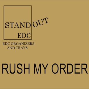 May include: A brown background with a black square containing the text "STAND OUT EDC" and the text "EDC ORGANIZERS AND TRAYS" below the square. The text "RUSH MY ORDER" is at the bottom of the image.