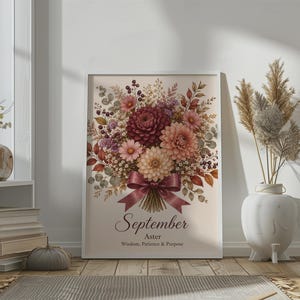 May include: A vertical wall art print featuring a bouquet of dahlias and asters in shades of burgundy, peach, and cream, tied with a dark ribbon. Below the flowers, the text reads September, Aster, and Wisdom, Patience & Purpose in black font.