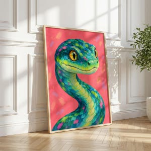 May include: A framed wall art print featuring a stylised painting of a snake with vibrant blue, green, and yellow scales against a bright pink background. The snake has large, expressive yellow eyes and a curved neck, rendered in visible brushstrokes.